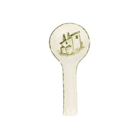 Decorative spoon rest with a house design on a white background