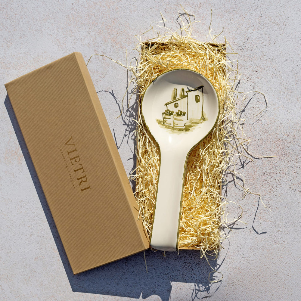 Decorative spoon rest with design in a box on a textured surface